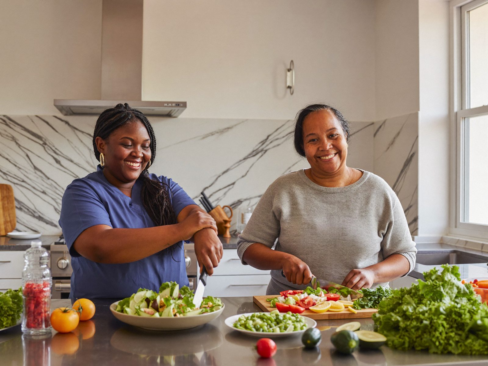 A support worker and a participant preparing a healthy meal together in a bright kitchen